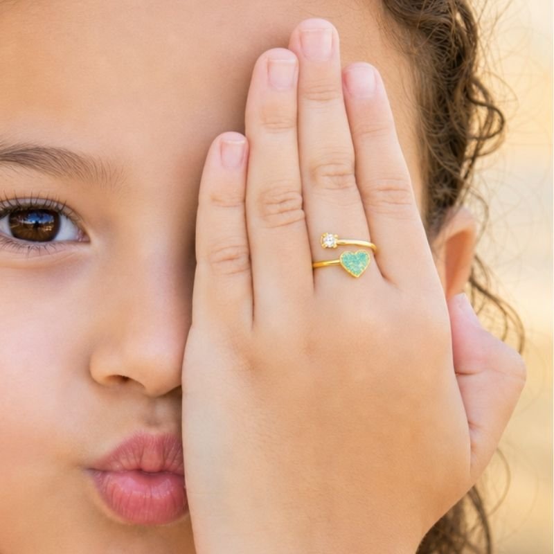 ANEL INFANTIL REGULÁVEL CORAÇÃO RESINADO COM GLITTER BANHADO EM OURO